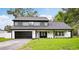 Beautiful two-story home featuring a well-manicured lawn and a two-car garage at 226 Willowick Ave, Temple Terrace, FL 33617