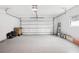 Spacious garage with an epoxy floor, a window, and an automatic door at 226 Willowick Ave, Temple Terrace, FL 33617