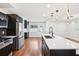 Contemporary kitchen boasts stainless steel appliances, shaker cabinets and a kitchen island with a black faucet at 226 Willowick Ave, Temple Terrace, FL 33617