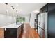 Contemporary kitchen with a white island, black cabinets, and stainless steel refrigerator at 226 Willowick Ave, Temple Terrace, FL 33617