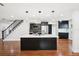 Stylish kitchen with black cabinets, a large island, and modern pendant lighting at 226 Willowick Ave, Temple Terrace, FL 33617