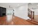 Open-concept living room with hardwood floors, fireplace, and stairway at 226 Willowick Ave, Temple Terrace, FL 33617