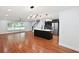 Spacious open-concept living room boasts hardwood floors, a kitchen and a modern light fixture at 226 Willowick Ave, Temple Terrace, FL 33617