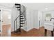 Unique spiral staircase off of a hallway with neutral walls and hardwood floors at 226 Willowick Ave, Temple Terrace, FL 33617