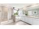 Luxurious bathroom with dual sinks, separate shower, and soaking tub, offering a relaxing retreat at 2264 Rikkola Ln, Wesley Chapel, FL 33543