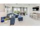 Spacious game room with comfortable seating, a pool table, and large windows offering scenic views at 2264 Rikkola Ln, Wesley Chapel, FL 33543