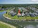 Aerial shot of a home with a pool in a waterfront community; lush greenery, backyard with pool, and waterfront view at 2829 Maple Brook Loop, Lutz, FL 33558