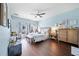 Comfortable primary bedroom with wood floors, a ceiling fan, and natural light at 2829 Maple Brook Loop, Lutz, FL 33558