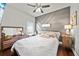 Cozy bedroom with hardwood floors, accent wall, and ample natural light from the large window at 2829 Maple Brook Loop, Lutz, FL 33558