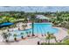 Aerial view of resort-style community pool with lap lanes, splash pad, and lush landscaping at 2829 Maple Brook Loop, Lutz, FL 33558