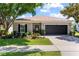 Charming single-story home with well-manicured lawn, landscape beds, and a two-car garage at 2829 Maple Brook Loop, Lutz, FL 33558