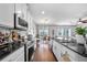 Well-appointed kitchen featuring stainless steel appliances, dark granite countertops, and seamless flow to dining/living at 2829 Maple Brook Loop, Lutz, FL 33558