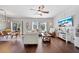 Bright living room with hardwood floors, comfortable seating, and access to the outdoor area at 2829 Maple Brook Loop, Lutz, FL 33558