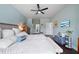 Spacious primary bedroom with wood floors, a ceiling fan, and ensuite bathroom at 2829 Maple Brook Loop, Lutz, FL 33558