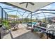 Screened lanai featuring outdoor seating and a swimming pool at 2829 Maple Brook Loop, Lutz, FL 33558