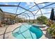 Beautiful kidney-shaped pool and spa is surrounded by a screened enclosure and brick patio at 2829 Maple Brook Loop, Lutz, FL 33558