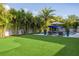 Spacious backyard featuring lush greenery, a putting green, and inviting lounge areas for outdoor enjoyment at 2902 S Beach Dr, Tampa, FL 33629