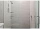 Modern shower featuring glass shelving, silver hardware, and neutral tile at 2902 S Beach Dr, Tampa, FL 33629