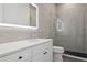 Bathroom featuring a modern vanity, illuminated mirror, and tiled walk-in shower at 2902 S Beach Dr, Tampa, FL 33629