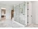 The primary bath boasts a steam shower, elegant fixtures and marble floors creating a serene and luxurious atmosphere at 2902 S Beach Dr, Tampa, FL 33629