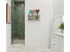 Stylish bathroom with green tiled shower, vanity, and elegant marble floors at 2902 S Beach Dr, Tampa, FL 33629