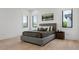 Bedroom features natural light from three windows and hardwood floors at 2902 S Beach Dr, Tampa, FL 33629