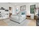 Bedroom featuring hardwood floors, a gray bed, and a view into the bathroom at 2902 S Beach Dr, Tampa, FL 33629