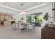 Bright dining area with sleek table, modern chandelier, and open layout at 2902 S Beach Dr, Tampa, FL 33629