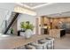 Bright, modern dining room with wood table, unique lighting and open floor plan to the kitchen at 2902 S Beach Dr, Tampa, FL 33629