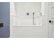 Close up of dog shower stall with white tile and fixtures at 2902 S Beach Dr, Tampa, FL 33629