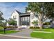 Elegant two-story home showcasing a well-maintained lawn and modern gray and white design elements at 2902 S Beach Dr, Tampa, FL 33629