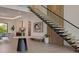 Elegant foyer featuring a unique staircase, modern decor, and ample natural light at 2902 S Beach Dr, Tampa, FL 33629