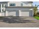 Two-car garage with an expansive driveway, seamlessly integrated into the home's exterior at 2902 S Beach Dr, Tampa, FL 33629