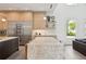 Bright, open kitchen with light wood cabinets, a marble island, and stainless steel appliances at 2902 S Beach Dr, Tampa, FL 33629