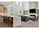 Open-concept kitchen with marble island and bar seating flowing into the bright, modern living area at 2902 S Beach Dr, Tampa, FL 33629