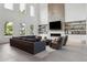Bright, modern living room with high ceilings, a fireplace, and an open floor plan to the kitchen at 2902 S Beach Dr, Tampa, FL 33629