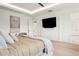 Modern bedroom features a mounted flat screen TV and sleek decor, blending comfort with contemporary technology at 2902 S Beach Dr, Tampa, FL 33629
