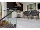 Outdoor kitchen and dining area with built-in grill, sink, and refrigerator at 2902 S Beach Dr, Tampa, FL 33629
