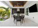 Outdoor kitchen featuring stainless steel appliances, granite countertops, and a dining area at 2902 S Beach Dr, Tampa, FL 33629