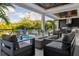 Outdoor living space with seating, a dining area, an outdoor kitchen, a fire pit, and a pool at 2902 S Beach Dr, Tampa, FL 33629