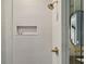 Beautiful shower with textured white tile, niche, and gold fixtures at 2902 S Beach Dr, Tampa, FL 33629
