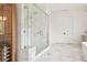 The luxurious shower has double shower heads, marble, and glass creating a spa-like experience at 2902 S Beach Dr, Tampa, FL 33629