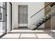 Modern staircase with floating steps, glass railing, and an elevator at 2902 S Beach Dr, Tampa, FL 33629