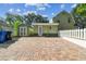 Exterior home showing a brick driveway, shed, and fenced yard at 301 81St Ne Ave, St Petersburg, FL 33702