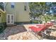 Patio with red lounge chairs, with access to the backyard and a relaxing outdoor space at 301 81St Ne Ave, St Petersburg, FL 33702
