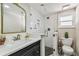 Modern bathroom with a glass-enclosed shower, sleek vanity, and stylish patterned floor tiles adding a touch of elegance at 301 81St Ne Ave, St Petersburg, FL 33702