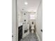 Contemporary bathroom featuring a glass walk-in shower, modern toilet, vanity, and stylish patterned floor tiles at 301 81St Ne Ave, St Petersburg, FL 33702