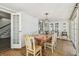 Elegant dining room with a large wooden table, chandelier, and access to the outdoor patio at 301 81St Ne Ave, St Petersburg, FL 33702