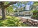 Charming two-story home featuring a lush front yard and inviting walkway to the front door at 301 81St Ne Ave, St Petersburg, FL 33702