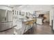 Open kitchen with a large island, stainless steel appliances, white cabinets and flows into living space at 301 81St Ne Ave, St Petersburg, FL 33702